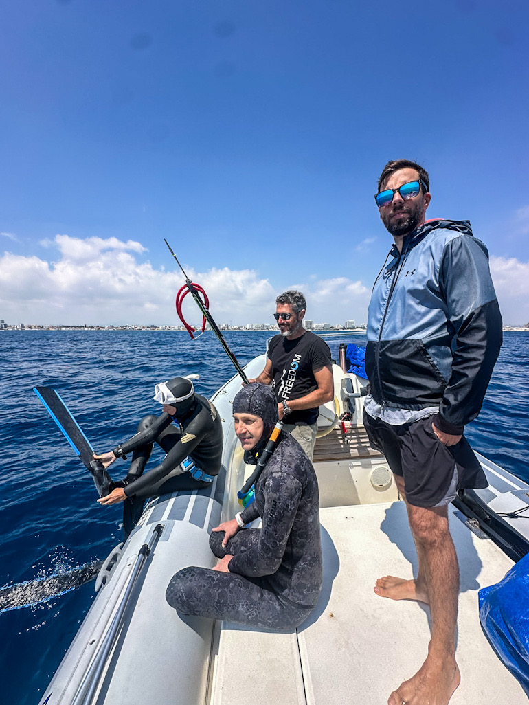 Spearfishers on the boat with gear ready, off the Larnaca coast